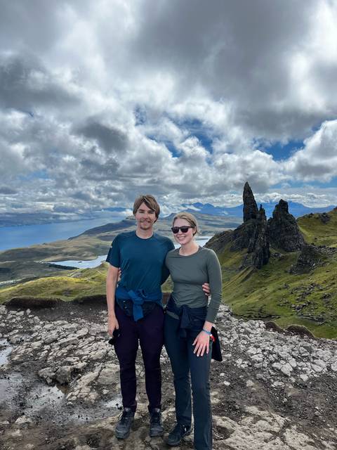 Couple with a scenic backdrop of mountains and water.