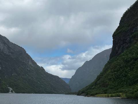       Scenic view of a valley between mountains with clouds.
  