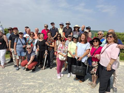 Large group of people posing outdoors.