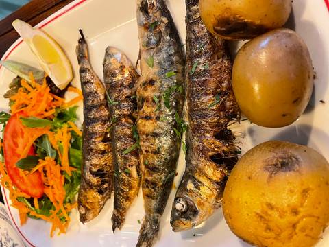       Grilled whole fish served with vegetables.
  