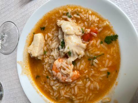 Rice dish with seafood in a rich sauce.