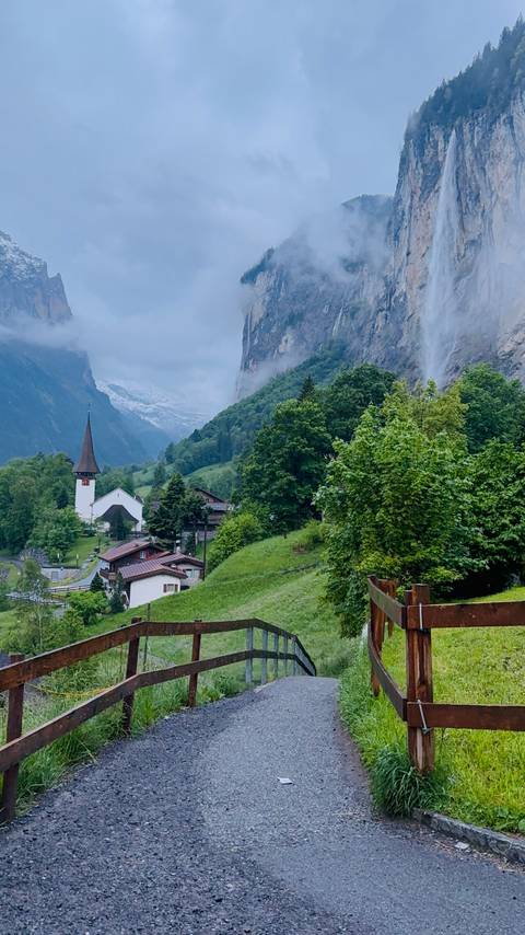 Scenic view of Lauterbrunnen Valley with church and mountains.