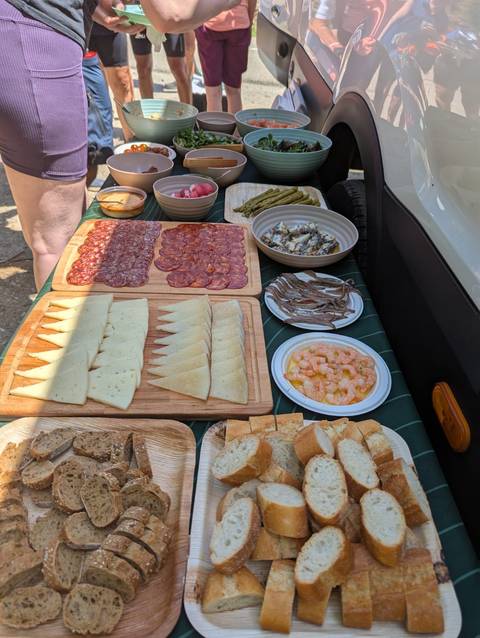 A variety of food items including cheese, cured meats, and shrimp on a table.