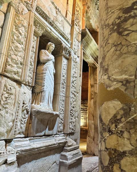 Close-up of an ancient statue in ruins.
