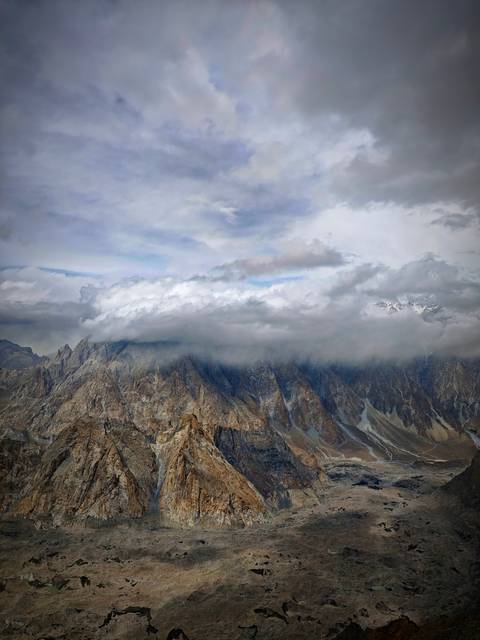 Clouds covering mountain peaks with dramatic landscape.