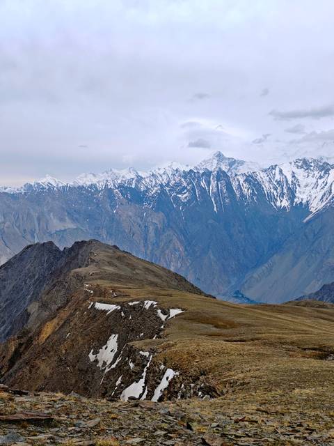 Expansive mountain landscape with snow-capped peaks.