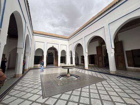 Courtyard with fountain and arched windows.