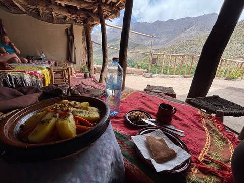       Traditional meal served on a table overlooking mountains.
  