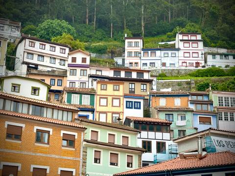       Colorful hillside houses stacked on a slope.
  