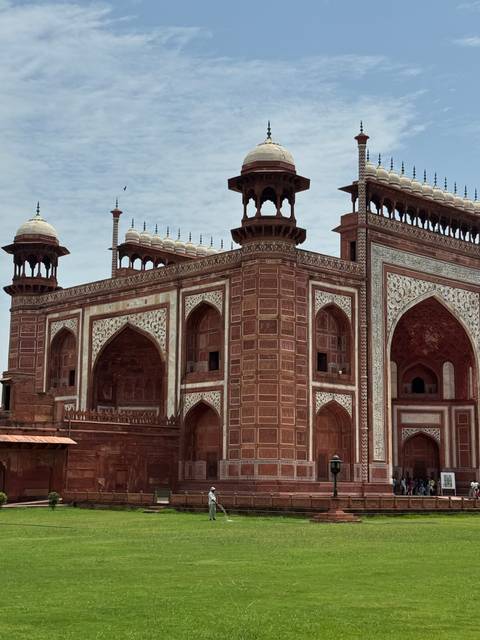 Detailed view of the red sandstone and marble gateway of the Taj Mahal.