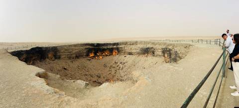       A large fiery crater in a barren landscape.
  