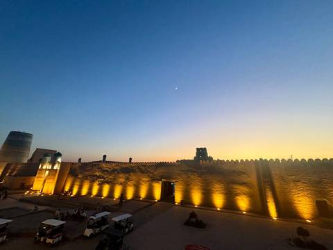       Ancient fortifications illuminated at dusk.
  