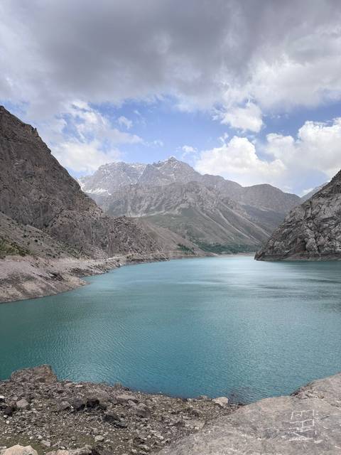       Beautiful mountain landscape with a serene blue lake surrounded by rocky peaks.
  
