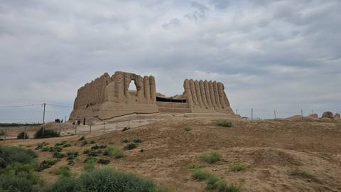       Ancient ruined structure with a cloudy sky above.
  