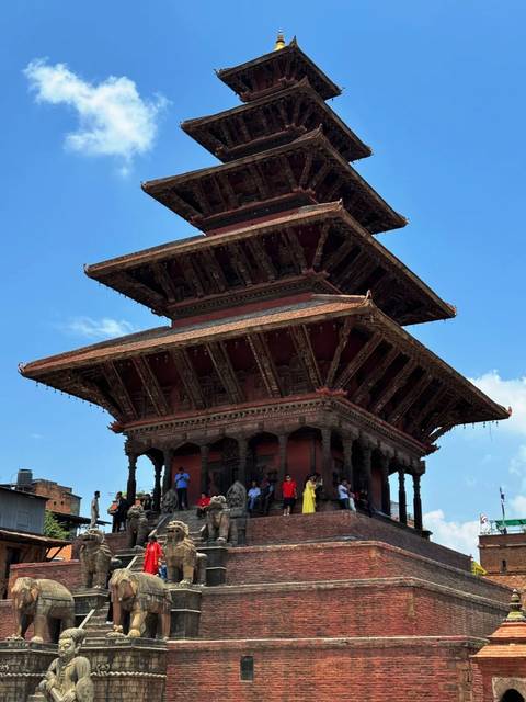 Traditional pagoda structure with people at the base.