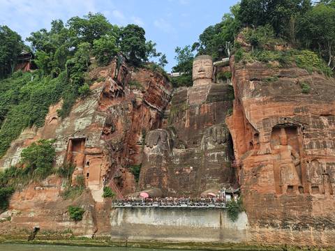 Leshan Giant Buddha carved into rock face.