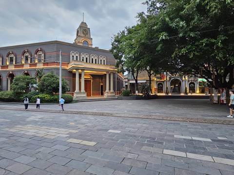 Open plaza with children playing and historic buildings.