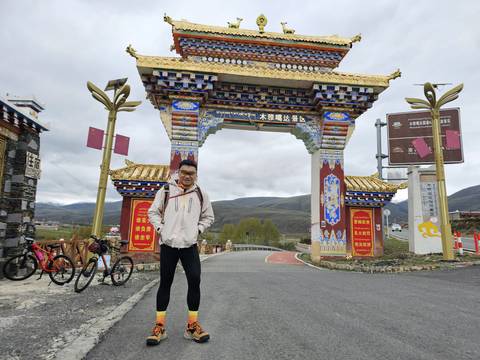 Decorative archway entrance with person and bicycles.