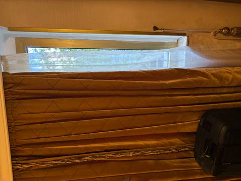 Drawn curtains in a room with sunlight peering through.