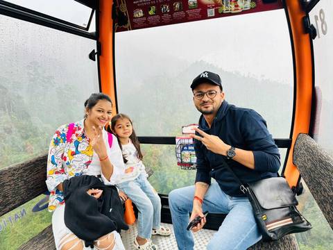       Family in a gondola on a misty day.
  