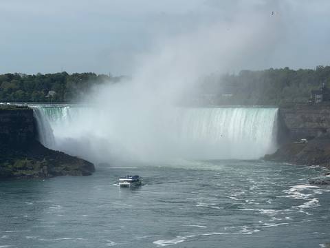 Niagara Falls with a boat approaching the mist.