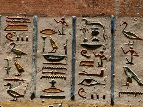 Colorful ancient Egyptian hieroglyphics on a wall.