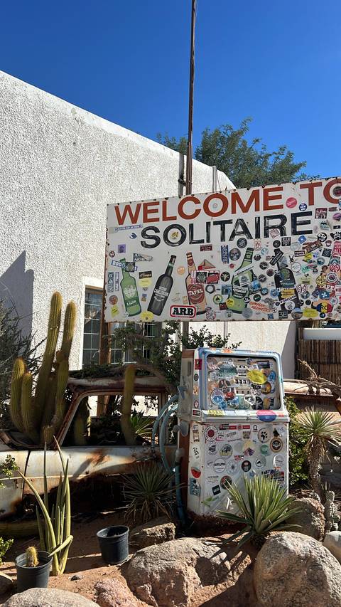 Welcome sign covered in stickers at Solitaire.