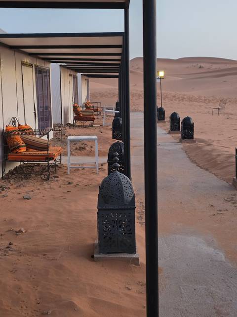 Outdoor seating with lanterns in desert setting.