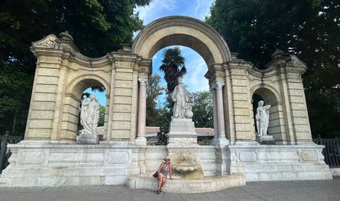 Tourists visiting historic architectural structure with archways.