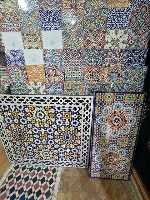 Colorful mosaic tiles with intricate patterns on display.