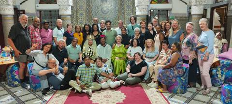       Group gathered in a beautifully tiled room, smiling for the camera.
  