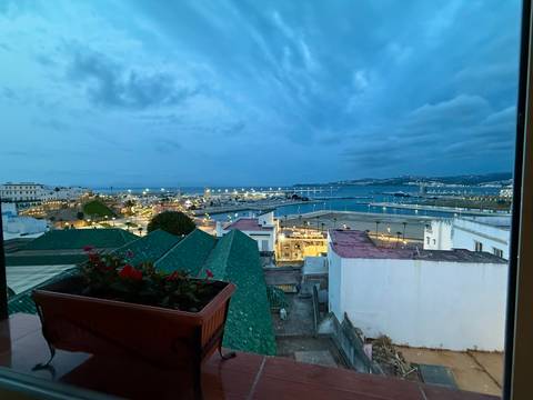City view overlooking a river with lights at dusk.