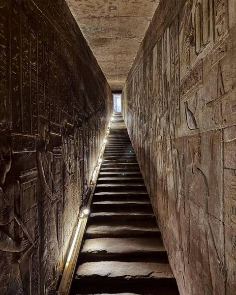 Staircase with ancient Egyptian wall carvings.