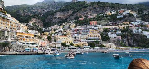       Coastal town with colorful houses and boats.
  