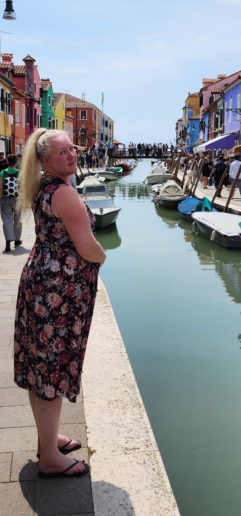       Person standing by a canal.
  