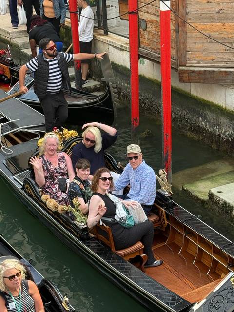       Group enjoying a gondola ride.
  