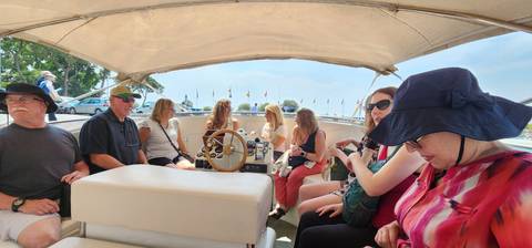       Group of people in a boat.
  