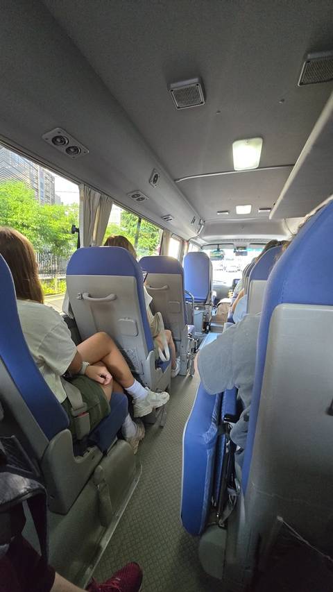       Interiors of a transport bus with passengers.
  