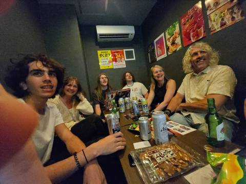       Group of people in a room with drinks and snacks.
  