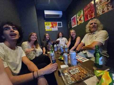       Group of people in a room with drinks and snacks.
  