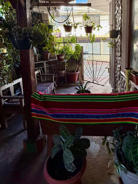       Colorful blanket on seating under a canopy.
  