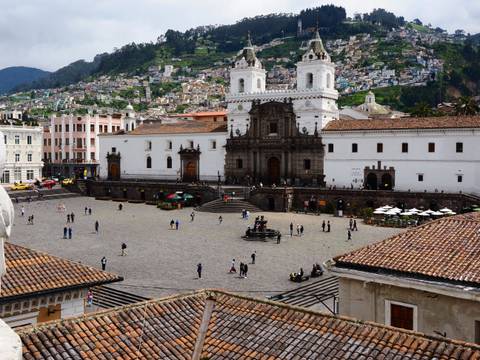 Public square with historical architecture and people.