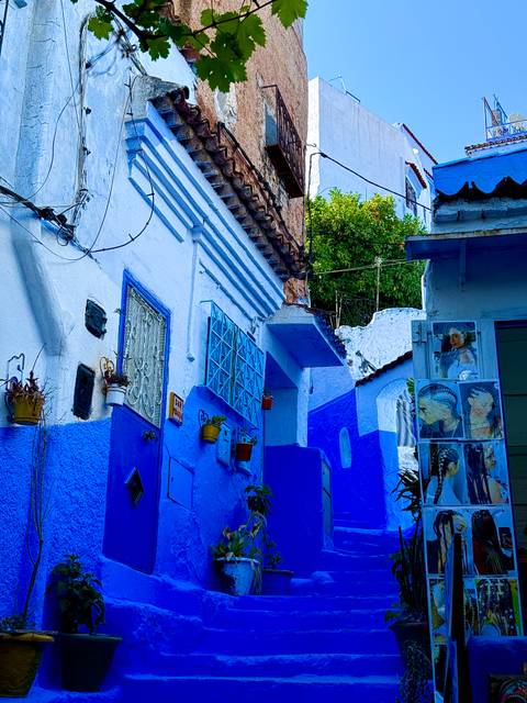 People enjoying tea inside a building with intricate decor.