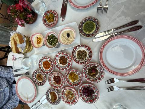 Diverse assortment of Moroccan dishes on a set dining table.