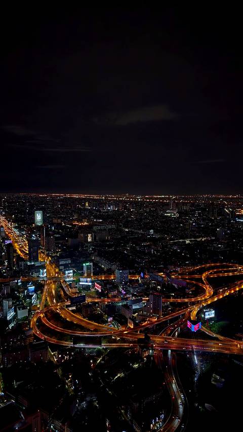 Nighttime panorama of a bustling city.