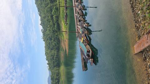       Boats docked along a clear blue lake.
  