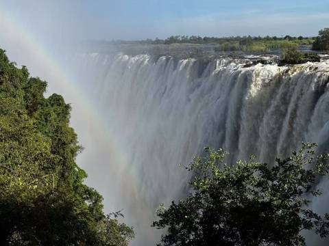       Victoria Falls with a rainbow over the waterfall.
  