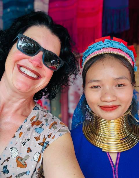       Two women posing for a selfie, one wearing traditional jewelry.
  