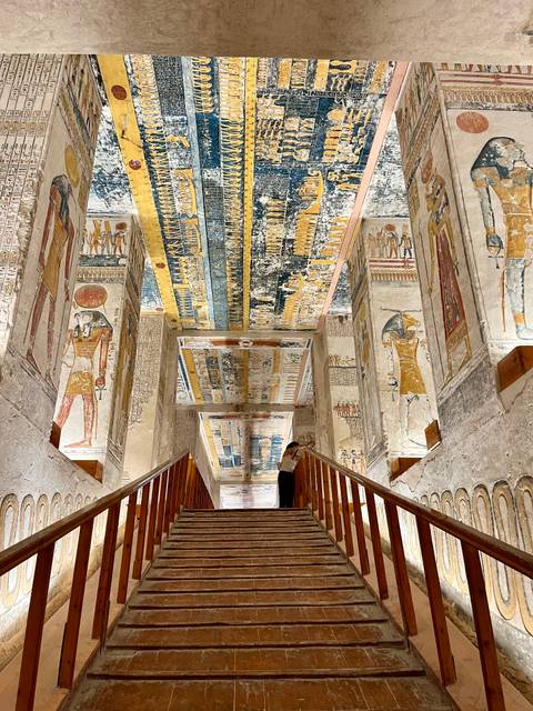 Beautifully decorated ancient Egyptian tomb interior with hieroglyphs.