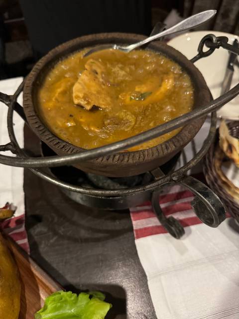Close-up of a pot of stew on a table.